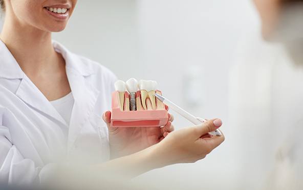 dentist explaining the dental implant process to a patient