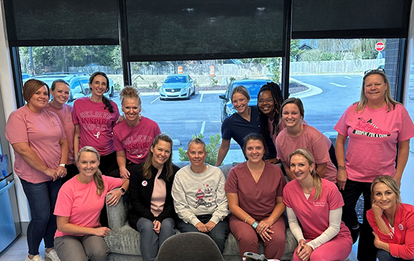 The Langworthy Family Dentistry team wearing breast cancer awareness shirts