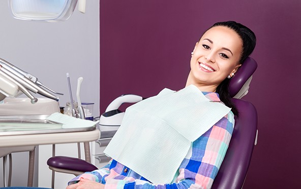 Female patient leaning back in dental chair