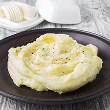 Mashed potatoes on a plate with butter