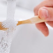 Rinsing off a toothbrush in the sink