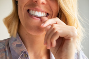 Woman inserting Invisalign tray